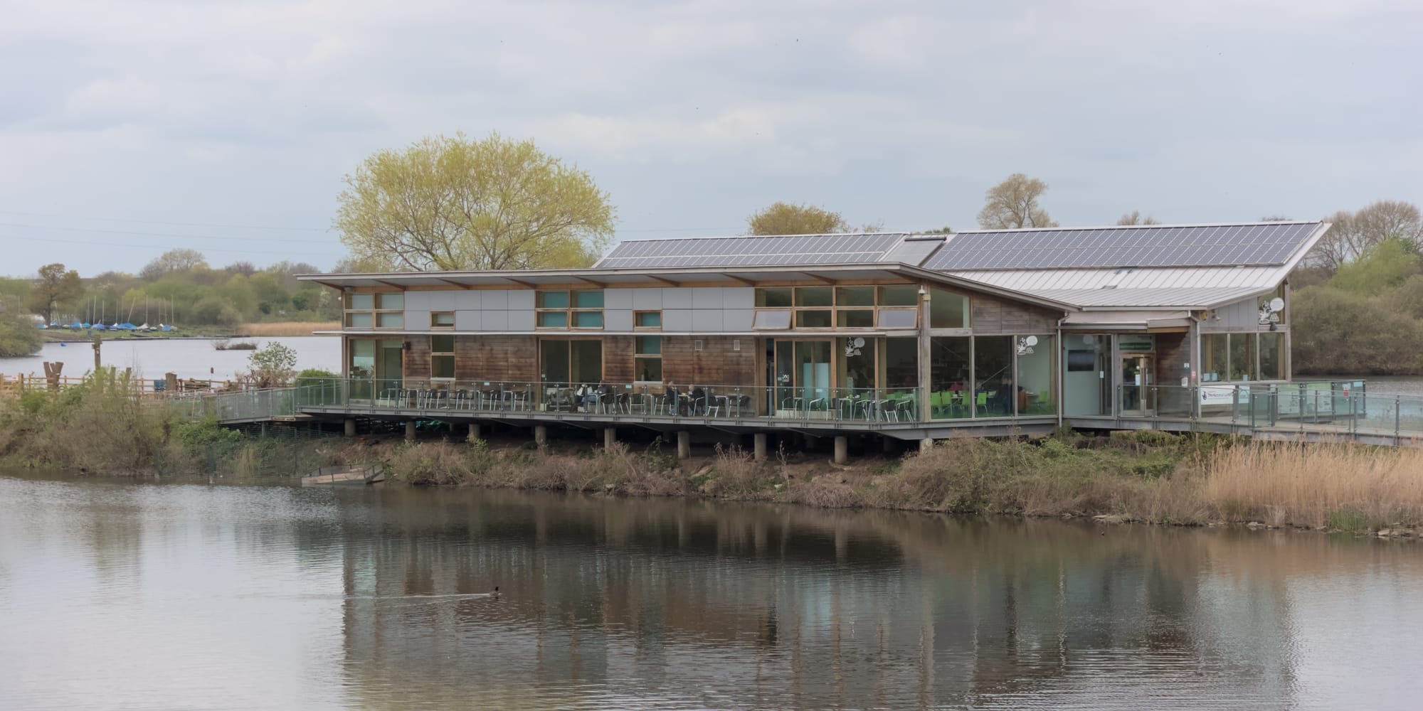 A view of the Attenborough Nature Centre sat between a pair of lakes.